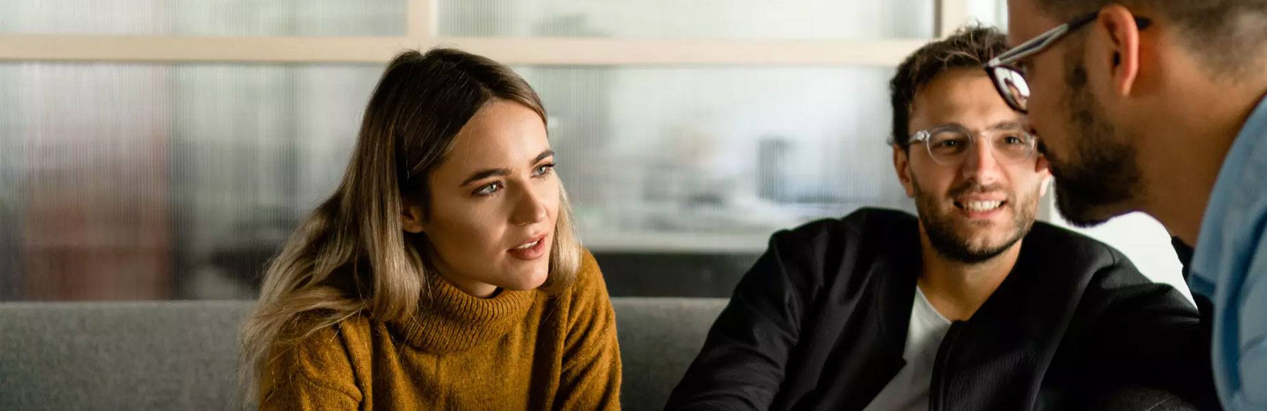 A young couple discussing finance options with a Suzuki Salesman