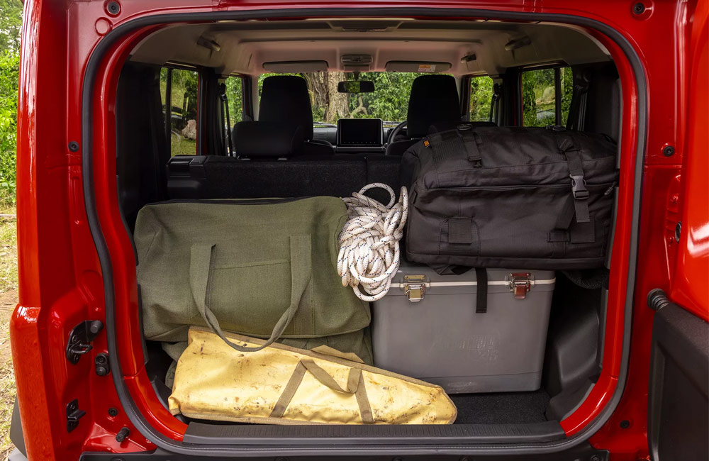 Bags of outdoor equipment loaded in the boot of an SUV