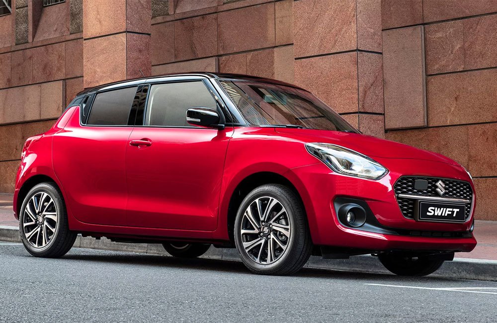 Red Swift with black roof parked on a street