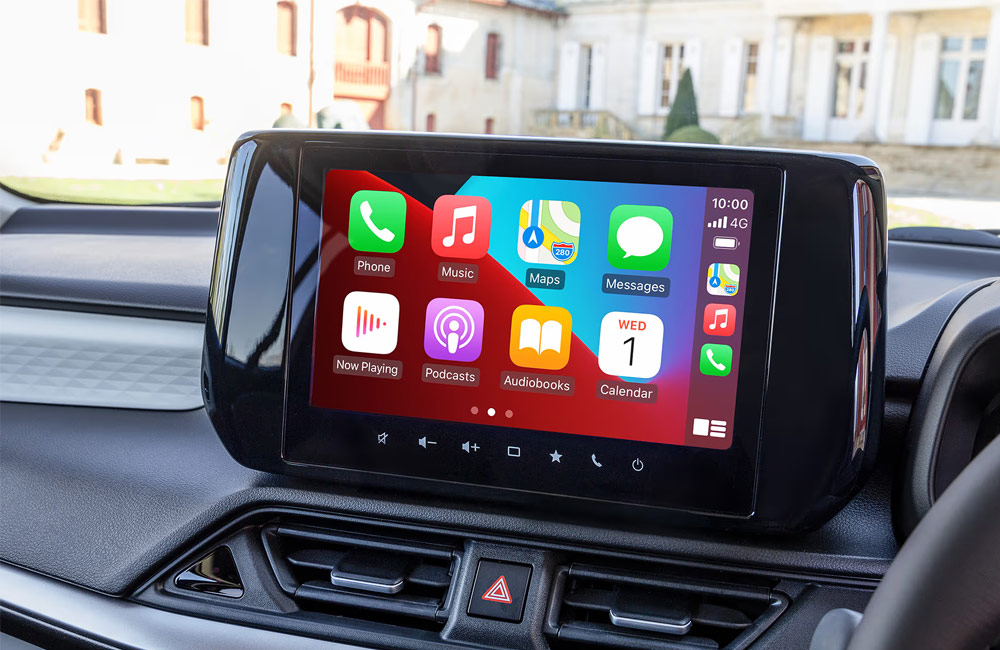 Blue Swift with black roof driving on a forest road